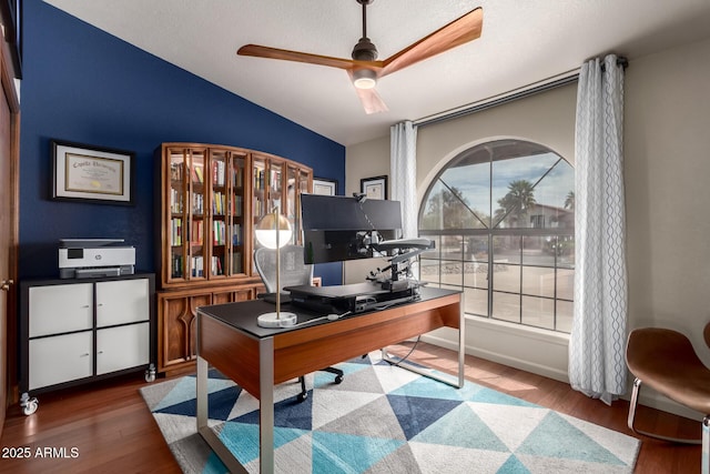 office area with ceiling fan, vaulted ceiling, and wood finished floors