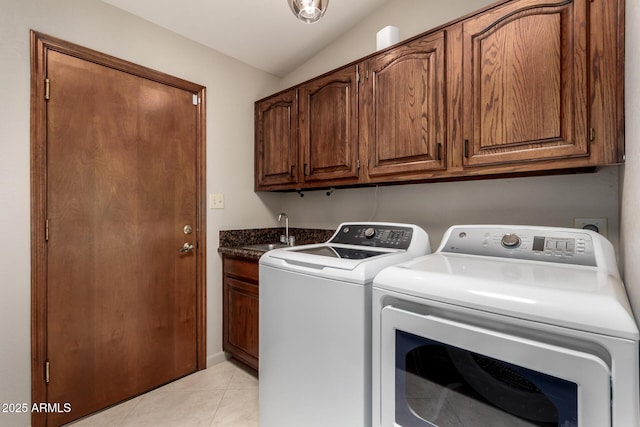 clothes washing area with light tile patterned flooring, a sink, cabinet space, and washer and dryer