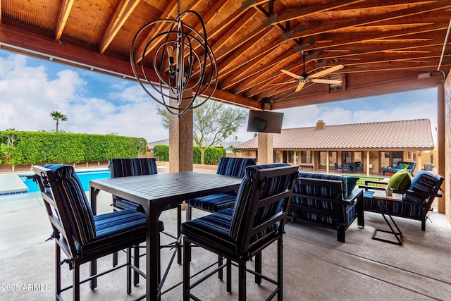 view of patio / terrace featuring a fenced in pool, outdoor dining space, outdoor lounge area, and ceiling fan