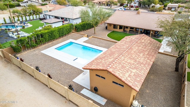 view of pool featuring a patio, a residential view, a fenced backyard, and a fenced in pool