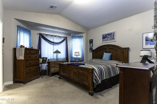 carpeted bedroom with vaulted ceiling