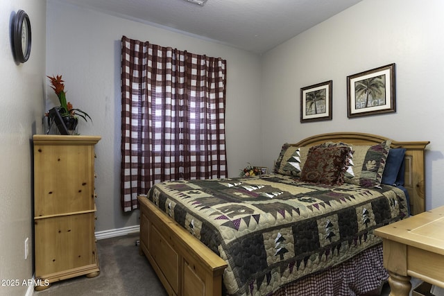 bedroom with dark colored carpet