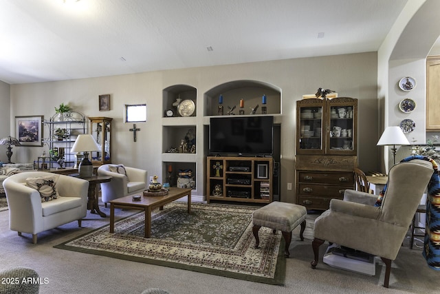 carpeted living room featuring built in features