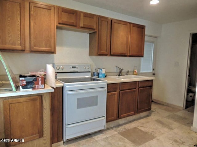 kitchen featuring white electric range and sink