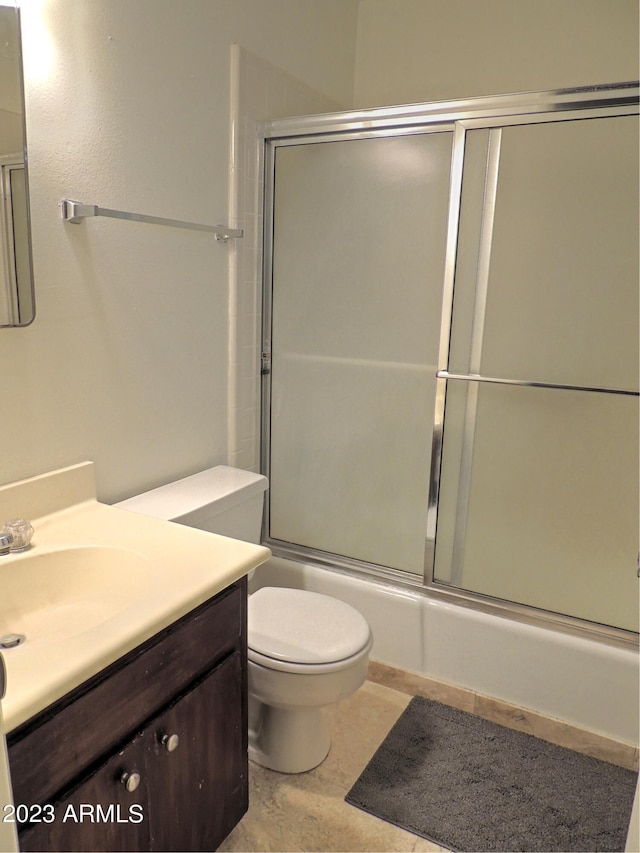 full bathroom with vanity, enclosed tub / shower combo, and toilet