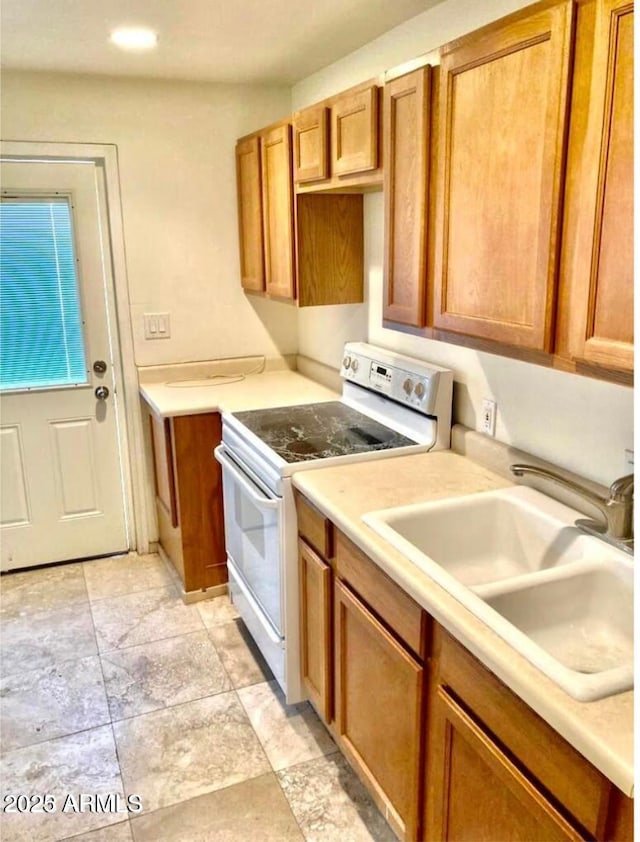 kitchen featuring white range with electric cooktop and sink