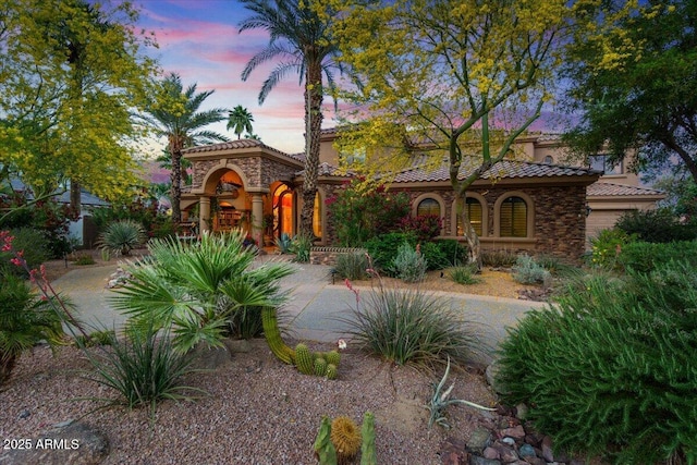 11821 S Tuzigoot Ct, Phoenix, AZ 85044 - mediterranean / spanish-style home featuring stucco siding, stone siding, and a tile roof