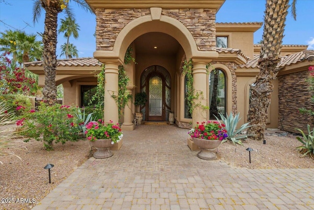 11821 S Tuzigoot Ct, Phoenix, AZ 85044 - view of exterior entry with stucco siding and stone siding
