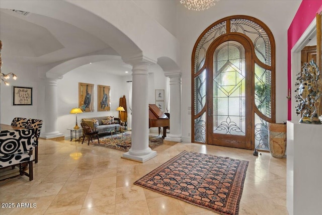 11821 S Tuzigoot Ct, Phoenix, AZ 85044 - foyer featuring baseboards, a high ceiling, visible vents, decorative columns, and arched walkways