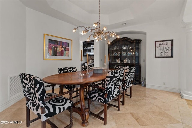 11821 S Tuzigoot Ct, Phoenix, AZ 85044 - dining room with visible vents, baseboards, an inviting chandelier, and a raised ceiling