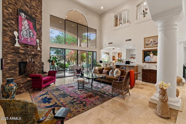 11821 S Tuzigoot Ct, Phoenix, AZ 85044 - tiled living room with visible vents, a high ceiling, a fireplace, ornate columns, and recessed lighting