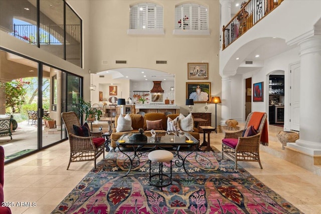 11821 S Tuzigoot Ct, Phoenix, AZ 85044 - tiled living room with ornate columns, a high ceiling, and visible vents