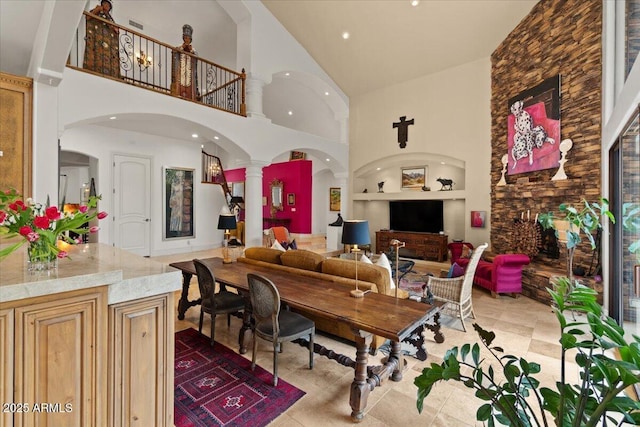 11821 S Tuzigoot Ct, Phoenix, AZ 85044 - tiled living area featuring built in features, decorative columns, recessed lighting, high vaulted ceiling, and arched walkways