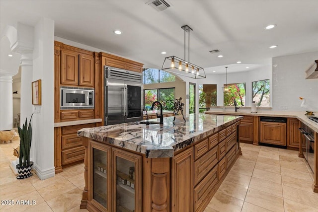 11821 S Tuzigoot Ct, Phoenix, AZ 85044 - kitchen with recessed lighting, built in appliances, brown cabinetry, and light tile patterned floors
