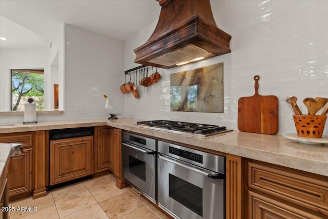 11821 S Tuzigoot Ct, Phoenix, AZ 85044 - kitchen featuring custom exhaust hood, light countertops, tasteful backsplash, and appliances with stainless steel finishes