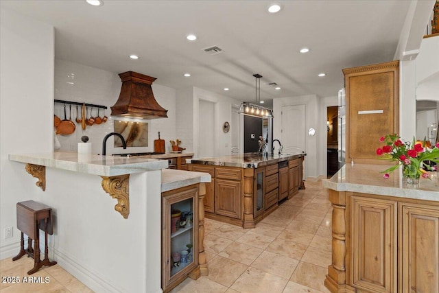 11821 S Tuzigoot Ct, Phoenix, AZ 85044 - kitchen with custom exhaust hood, visible vents, a kitchen breakfast bar, brown cabinets, and recessed lighting