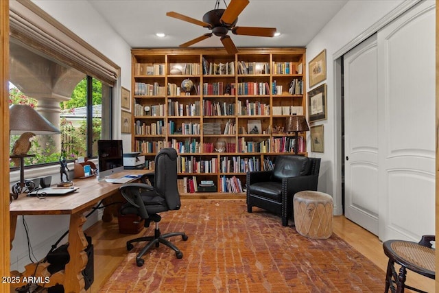 11821 S Tuzigoot Ct, Phoenix, AZ 85044 - office space featuring built in shelves, a ceiling fan, wood finished floors, and recessed lighting