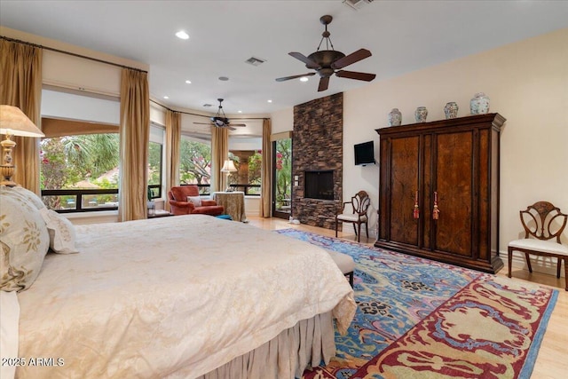 11821 S Tuzigoot Ct, Phoenix, AZ 85044 - bedroom featuring ceiling fan, a stone fireplace, visible vents, recessed lighting, and light wood finished floors