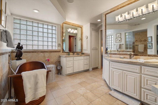 11821 S Tuzigoot Ct, Phoenix, AZ 85044 - bathroom with tile walls, two vanities, tile patterned flooring, and a healthy amount of sunlight