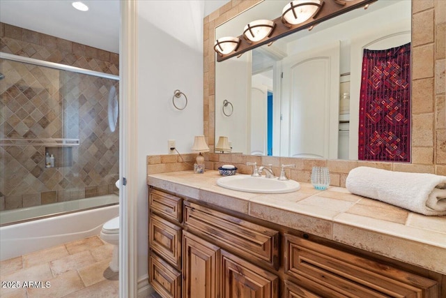 11821 S Tuzigoot Ct, Phoenix, AZ 85044 - full bathroom with combined bath / shower with glass door, toilet, stone finish floor, and vanity
