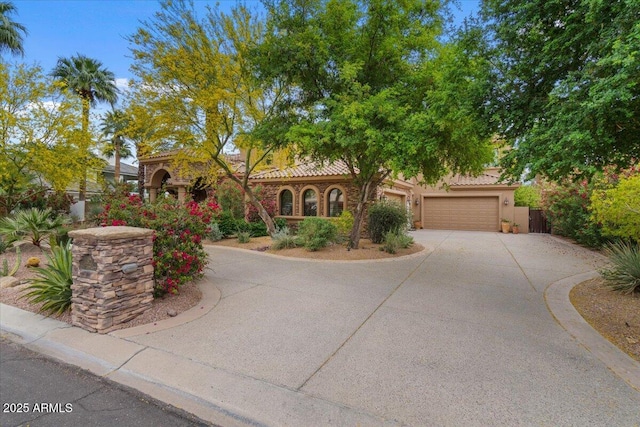 11821 S Tuzigoot Ct, Phoenix, AZ 85044 - view of front of house featuring a tiled roof, a garage, fence, stucco siding, and driveway