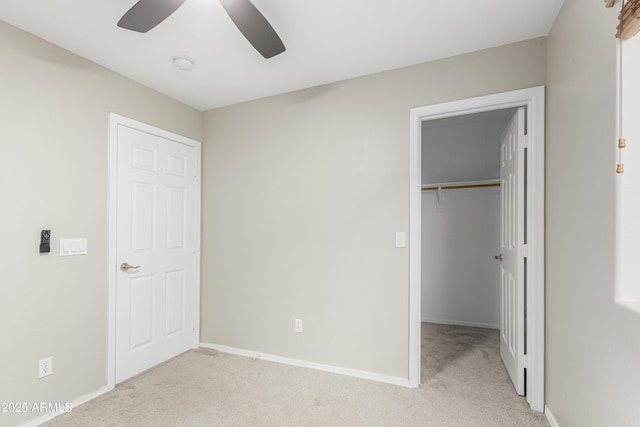 3910 W Goldmine Mountain Dr, San Tan Valley, AZ 85144 - unfurnished bedroom with light carpet, a spacious closet, a closet, and a ceiling fan