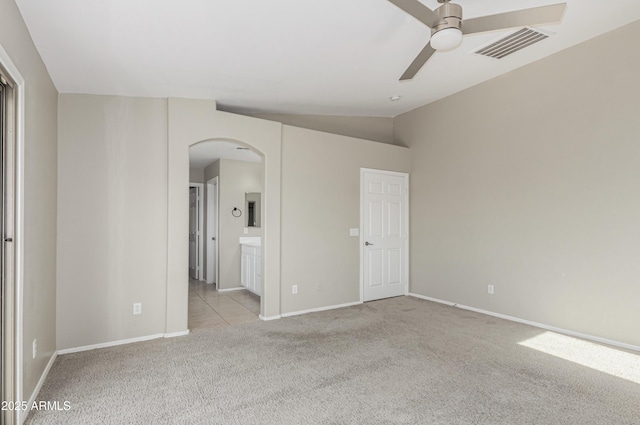 3910 W Goldmine Mountain Dr, San Tan Valley, AZ 85144 - unfurnished bedroom featuring carpet floors, arched walkways, ensuite bath, and a ceiling fan