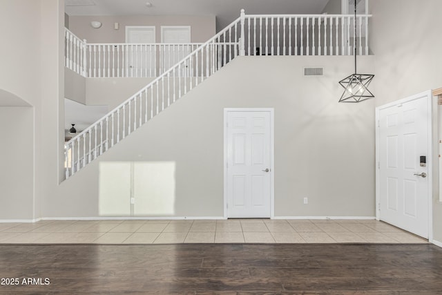 3910 W Goldmine Mountain Dr, San Tan Valley, AZ 85144 - entrance foyer with a high ceiling, wood finished floors, stairs, and arched walkways