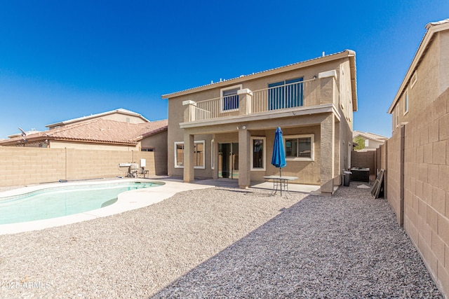 3910 W Goldmine Mountain Dr, San Tan Valley, AZ 85144 - rear view of house featuring a balcony, stucco siding, a fenced backyard, and a patio