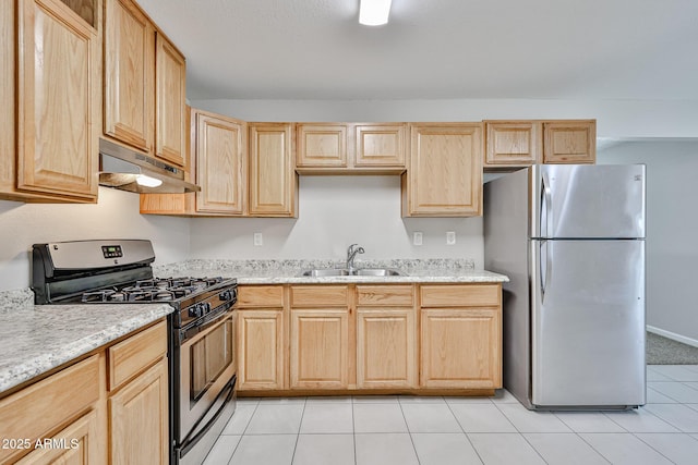 kitchen featuring under cabinet range hood, light brown cabinetry, appliances with stainless steel finishes, and a sink