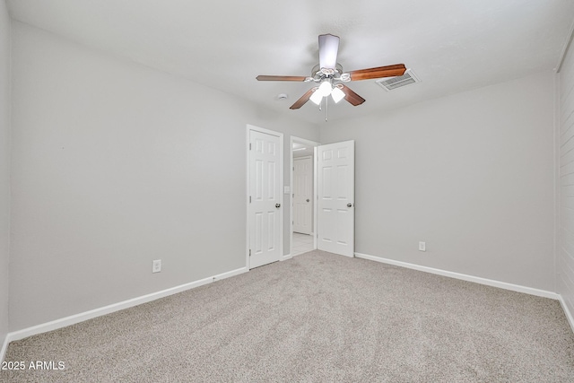 unfurnished bedroom with visible vents, baseboards, carpet floors, and ceiling fan