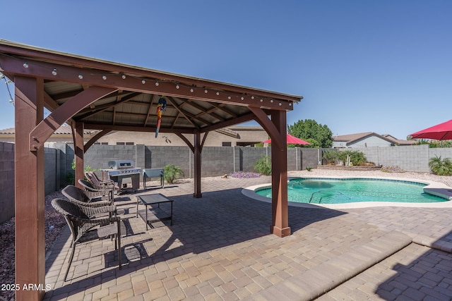 view of swimming pool with a gazebo, a patio area, a fenced in pool, and a fenced backyard