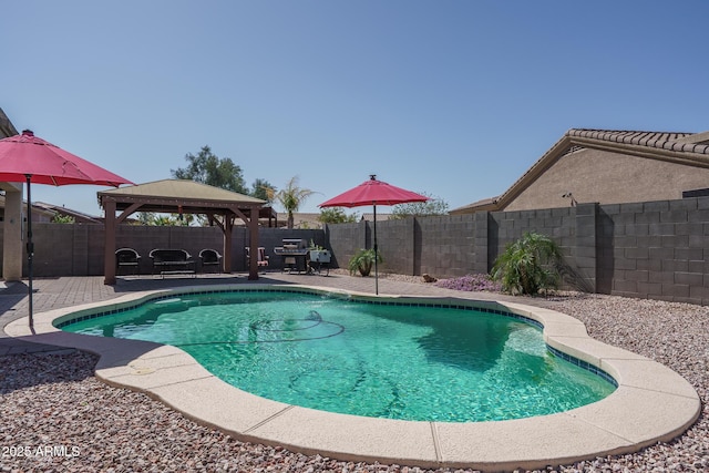 view of swimming pool with a gazebo, a patio area, a fenced in pool, and a fenced backyard