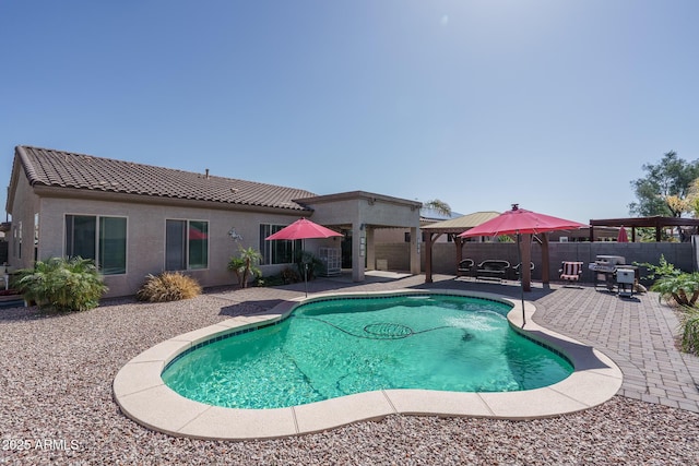 view of swimming pool featuring a patio area and fence