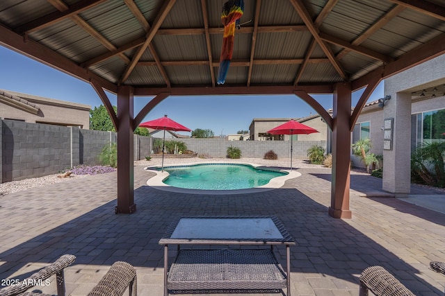 view of pool with a gazebo, a patio area, a fenced backyard, and a fenced in pool