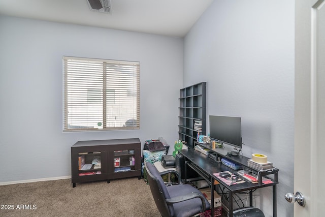 carpeted office space featuring visible vents and baseboards