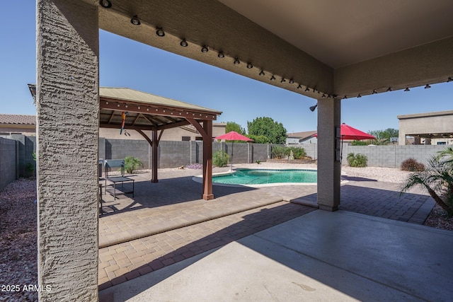 view of patio featuring a gazebo, a fenced backyard, and a fenced in pool