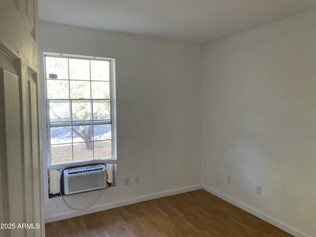 unfurnished room with hardwood / wood-style flooring