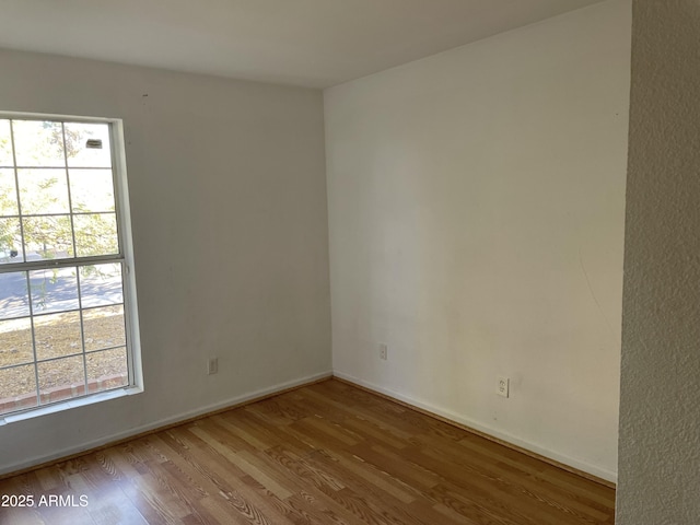 unfurnished room with a wealth of natural light and light wood-type flooring