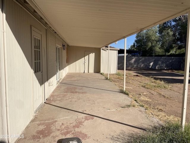 view of patio featuring a shed