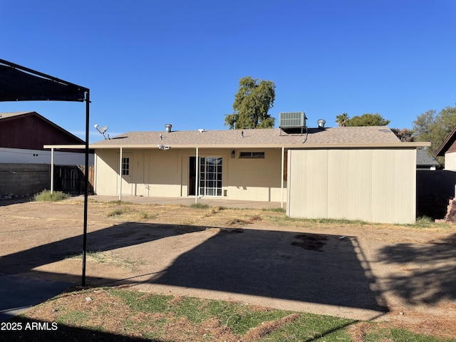 rear view of house featuring central air condition unit