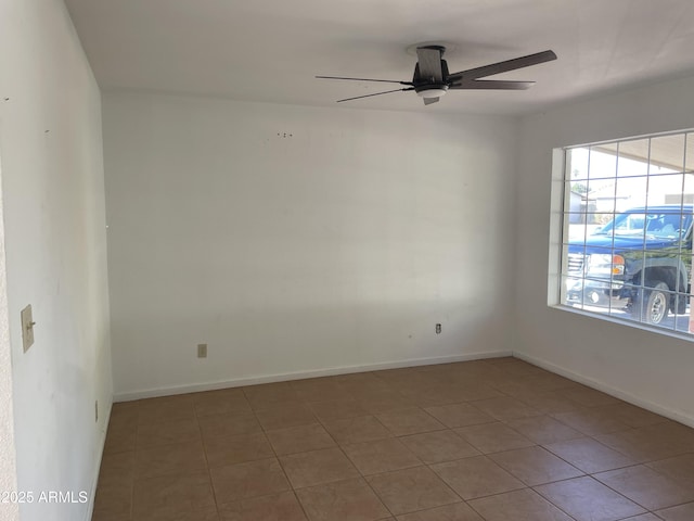 unfurnished room with tile patterned floors and ceiling fan