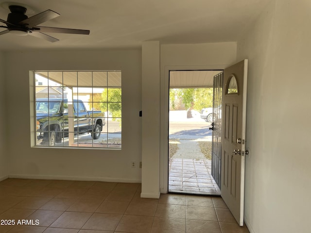 doorway to outside featuring ceiling fan, a healthy amount of sunlight, and tile patterned flooring