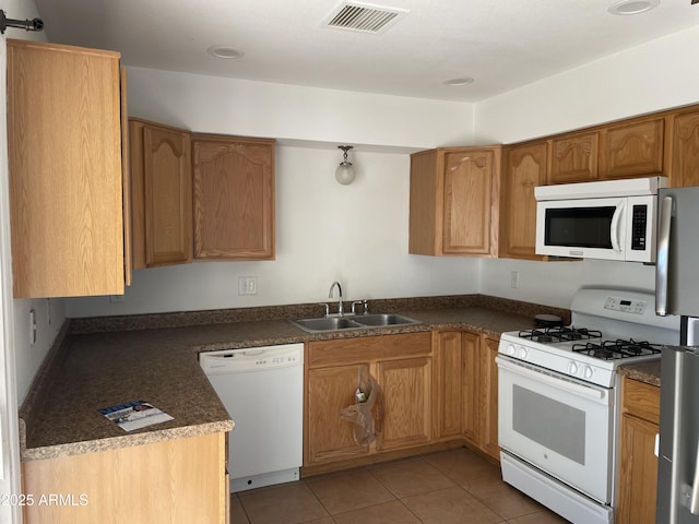 kitchen with light tile patterned flooring, sink, and white appliances