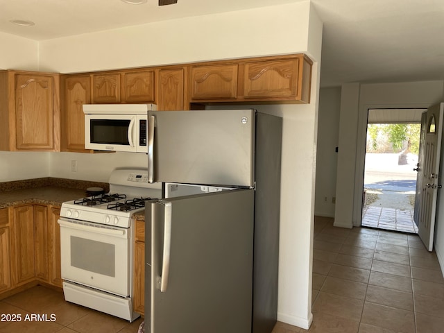 kitchen with white appliances and tile patterned floors