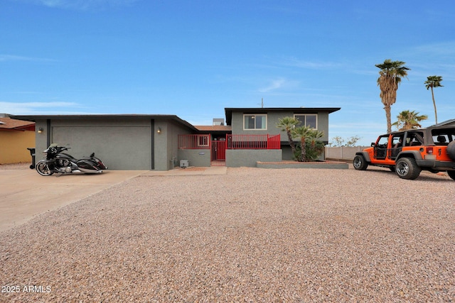 view of front of home featuring a garage, a fenced front yard, and concrete driveway