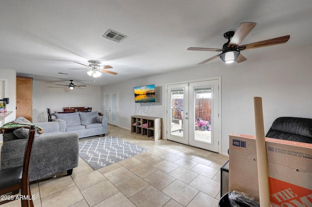 living area with french doors, light tile patterned flooring, and visible vents