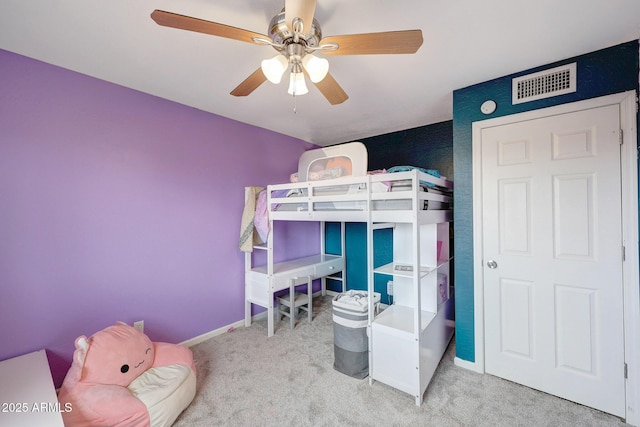 bedroom with carpet floors, visible vents, ceiling fan, and baseboards