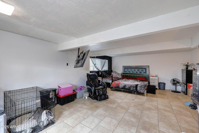 bedroom featuring light tile patterned floors, beamed ceiling, and a textured ceiling