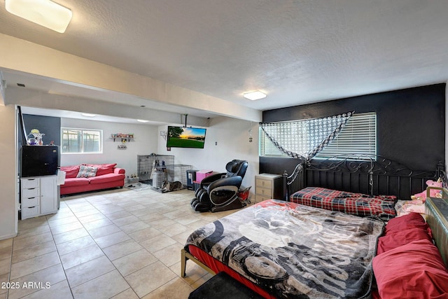 bedroom featuring a textured ceiling and light tile patterned floors